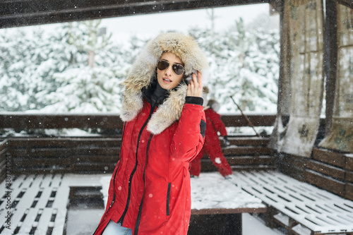 A portrait of beautiful caucasian girl in glases outdoor in snowy winter