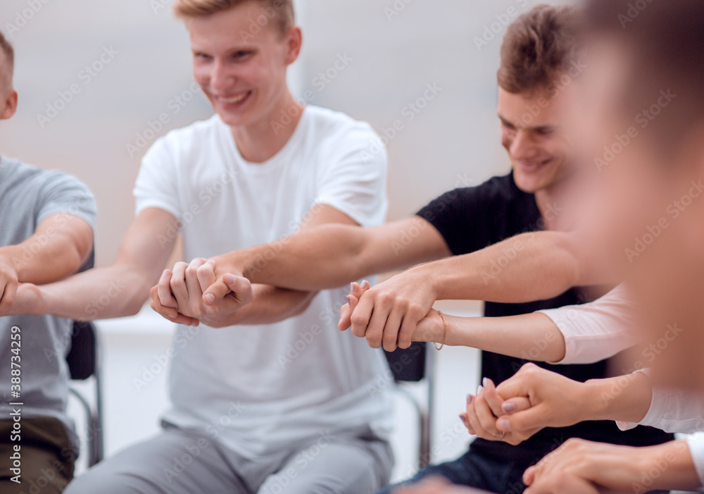 close up. diverse young people taking each other's hands close up. diverse young people taking each other's hands