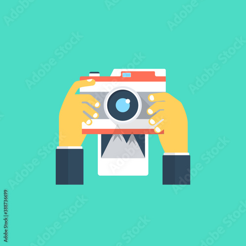 
Hand held camera clicking photos depicting photography process
