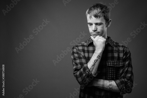 Portrait of hipster man against gray background