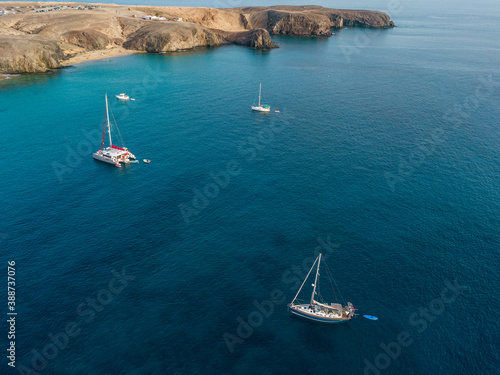 Aerial view of a catamaran and boats, near the shores of the island of Lanzarote, Canaries, Spain