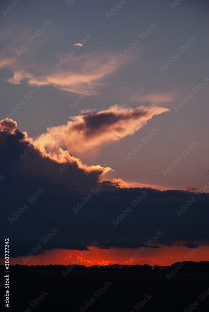 Orange colour of the sunset sky, cloud like in the fire, amazing colours of the sunset 