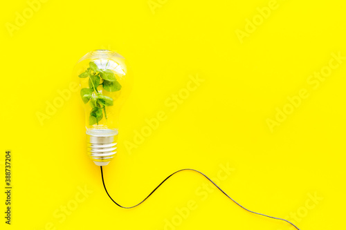 Light bulb with green grass - renewable energy eco concept