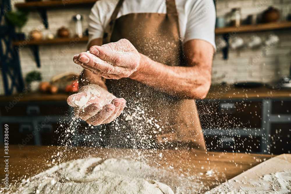 Male chef preparing dough for baking at home