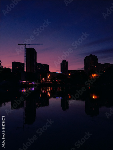 Pink sky and reflections in the water, calm evening atmosphere , evening lights 