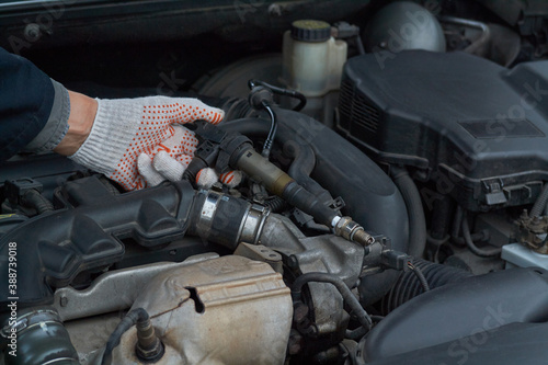 Man checks ignition coil and spark plug operation