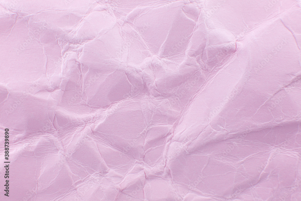 Crumpled pink paper background. Real macro battered texture. Close up photo.