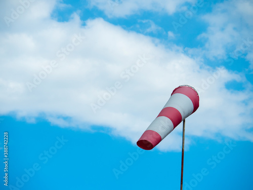 striped windsock at the airport on the background of beautiful clouds