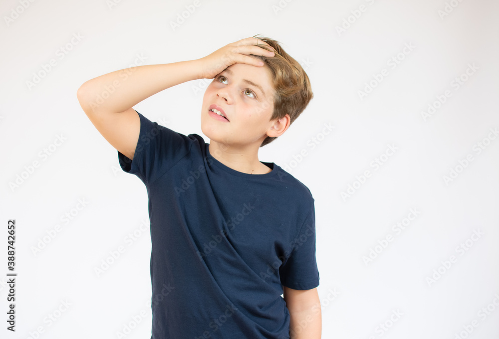 Little boy standing thinking on white background isolated, boy look up and copy space Little boy standing thinking on white background isolated, boy look up and copy space