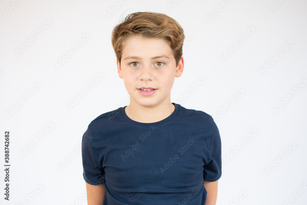 Photo of adorable young happy boy looking at camera over white background. Photo of adorable young happy boy looking at camera over white background.