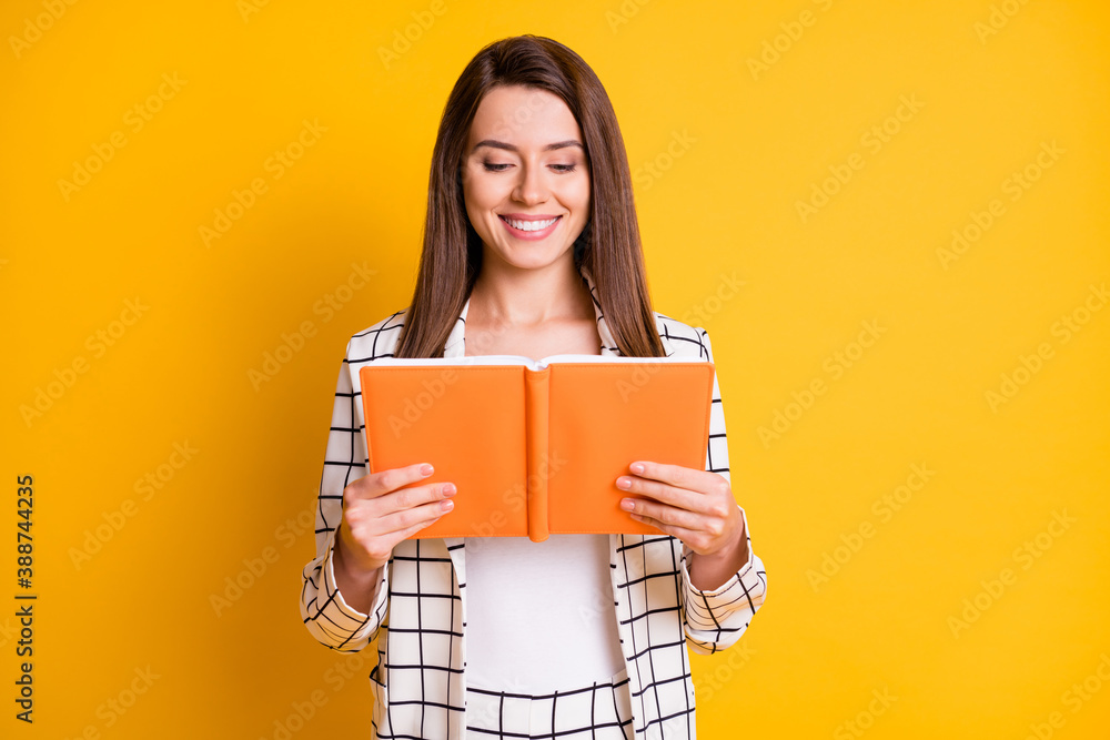 Photo of smiling shiny toothy clever lady reading book wear plaid outfit isolated yellow color background