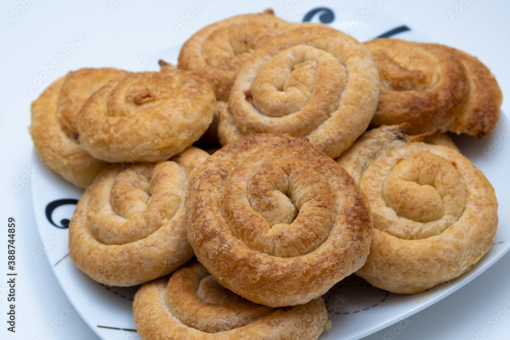 Sweet cinnamon rolls on a white plate Sweet cinnamon rolls on a white plate