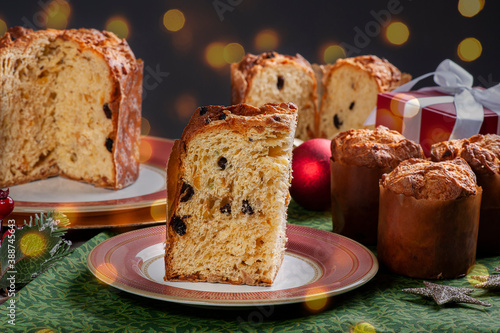.Artisanal panettone of natural fermentation, with chocolate and chestnuts. Christmas dessert. Bokeh lights