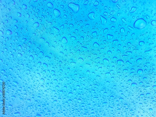 Close up texture water droplets raindrop on beautiful blue metallic background image for abstract background.
