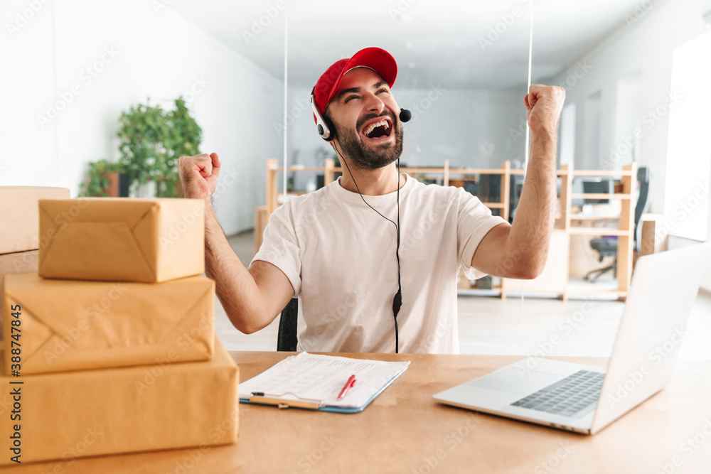 Happy call center worker at parcel distribution center Happy call center worker at parcel distribution center