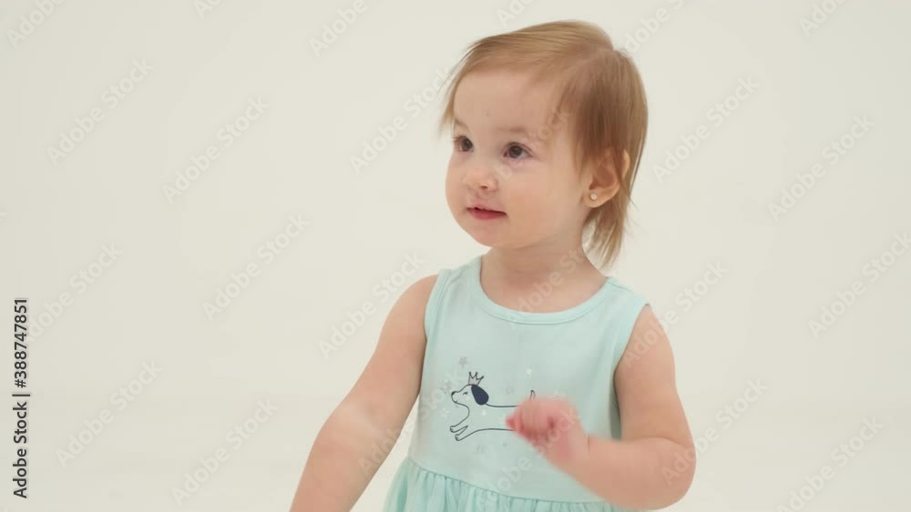 Happy little girl in mint-colored dress is dancing. Slow motion Happy little girl in mint-colored dress is dancing. Slow motion
