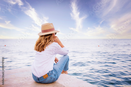 Full length shot of woman daydreaming while relaxing by the sea © sepy
