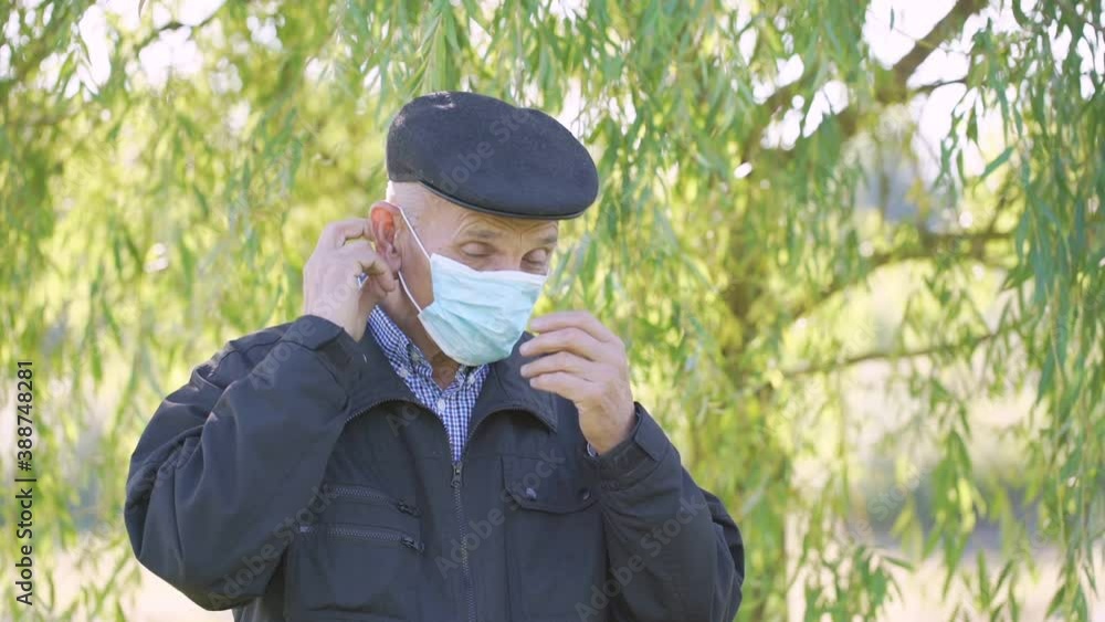 mature male person wearing protective face mask for health safety in city park mature male person wearing protective face mask for health safety in city park
