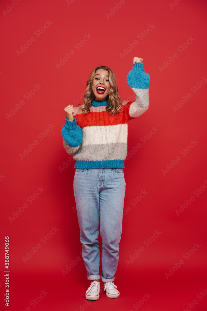 Smiling young girl wearing sweater standing isolated Smiling young girl wearing sweater standing isolated