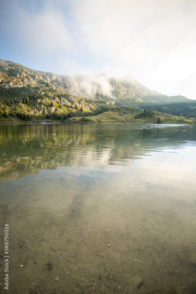 Fototapeta premium Mountain Bettmeralp village Switzerland at sunrise with fog