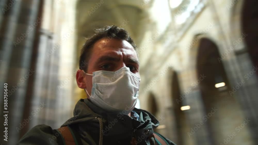 The man in the mask is spinning in place in the temple. Breathing protection for tourists in a public place. Dizziness during the excursion. The man in the mask is spinning in place in the temple. Breathing protection for tourists in a public place. Dizziness during the excursion.