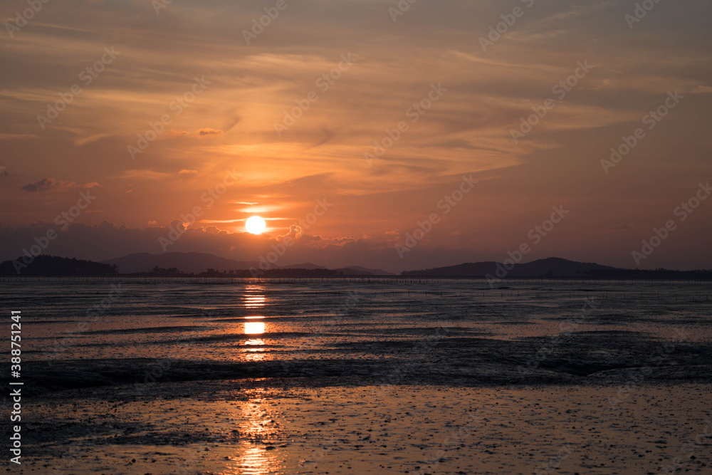 The mud flat where the sunset is reflected The mud flat where the sunset is reflected