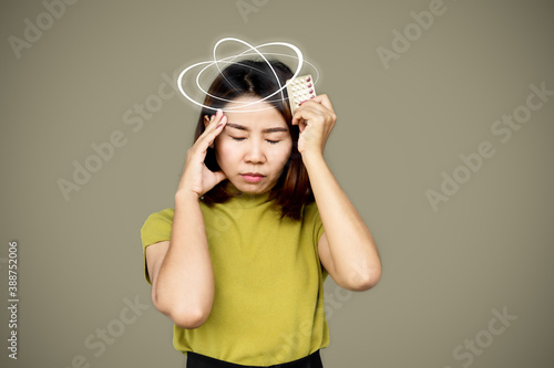 Asian woman suffering from dizziness having side effect from birth control pills 