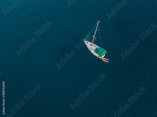 Aerial view of boats moored in the Atlantic Ocean at the jagged shores and beaches of Lanzarote, Spain, Canary Islands © Naeblys