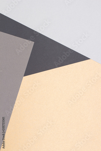Creative abstract geometric paper background light gray, black colors and brown craft paper. Top view. Copy space