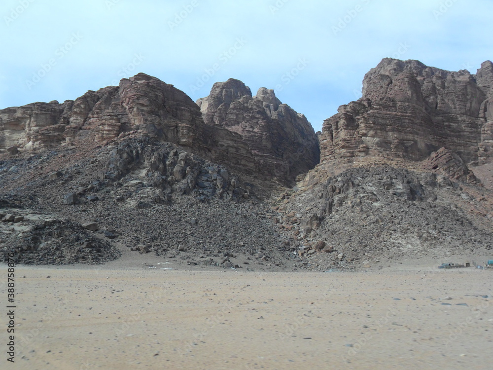 Hiking in the red desert sandcliffs and dunes of Wadi Rum in Jordan, Middle East