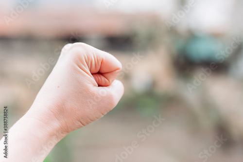 Close-up photo of female fist. Fight for women rights. Space for text © stivog