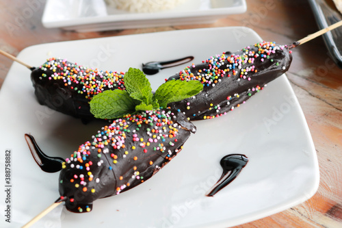 Chocolate covered bananas with sticks photo