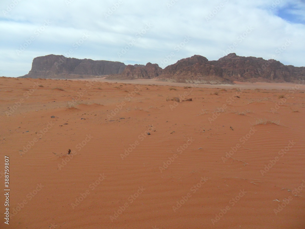 Hiking in the red desert sandcliffs and dunes of Wadi Rum in Jordan, Middle East