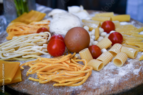 Different kind of uncooked italian pasta and ingredients