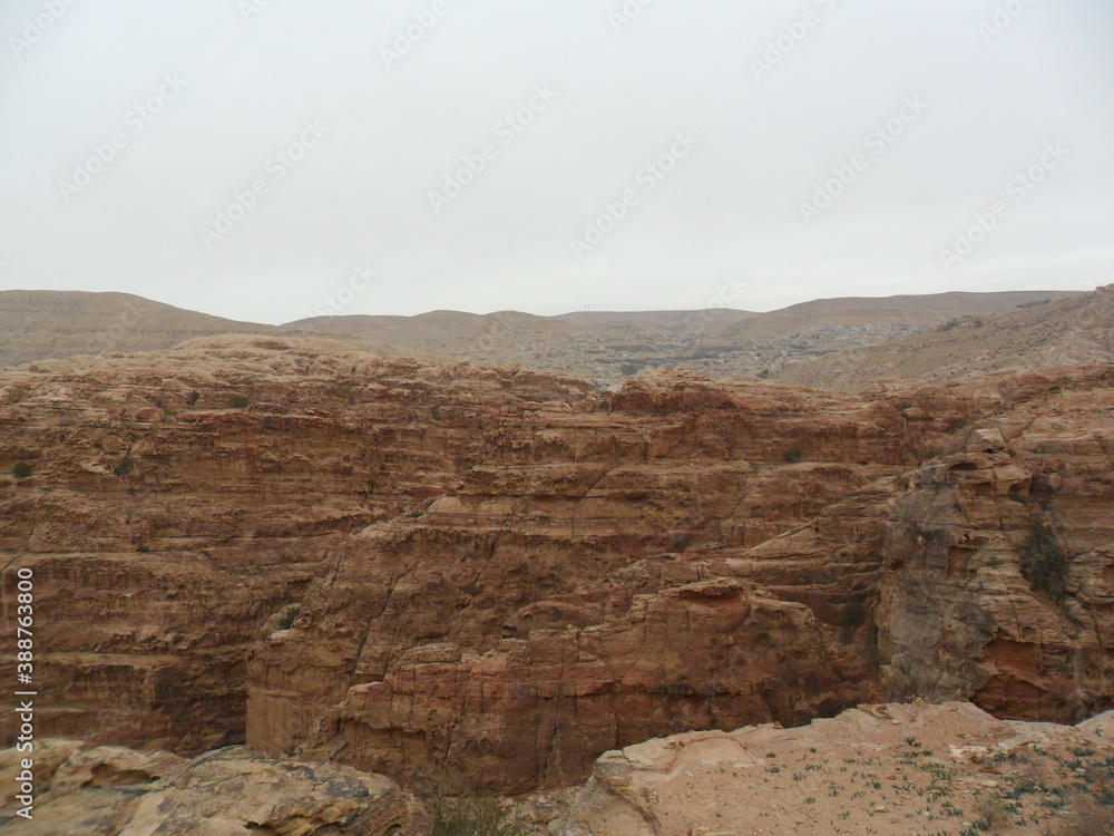 Obraz premium Hiking in the red sand dunes and cliffs of Wadi Rum and Petra archeological site in Jordan, Middle East