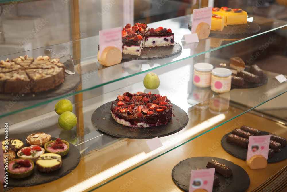 Delicious raw vegan desserts for sale on the showcase at confectionery store
