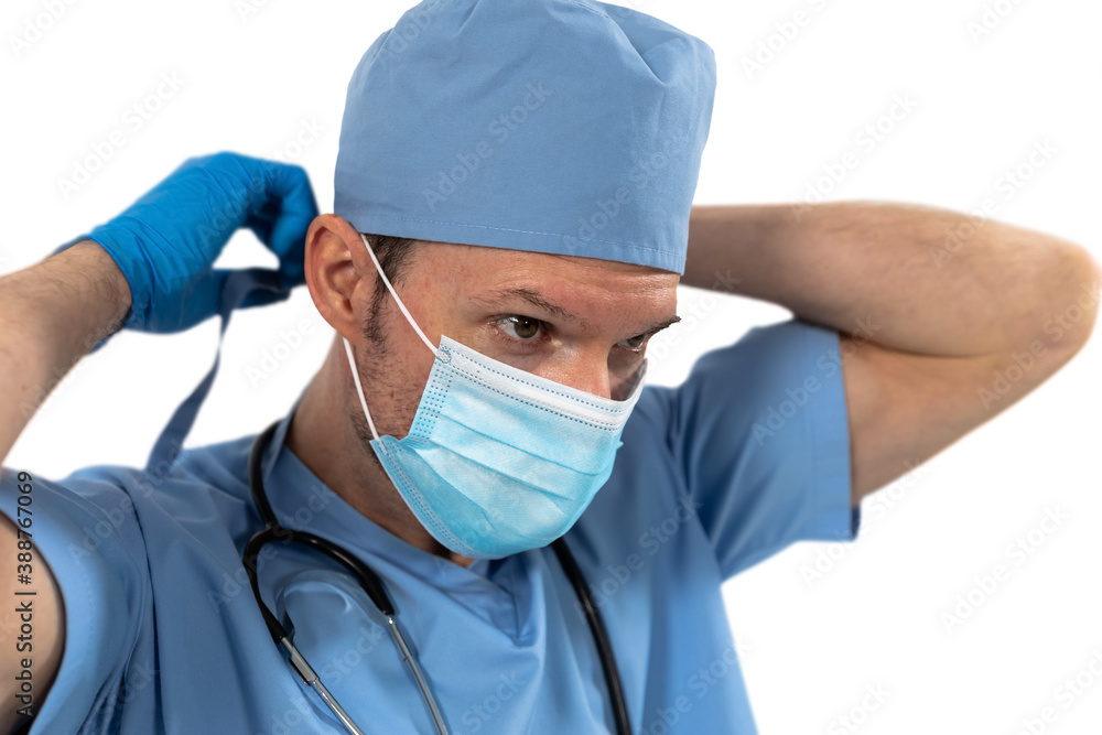 Male surgeon wearing face mask against white background Male surgeon wearing face mask against white background