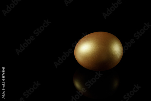 Golden egg isolated on black