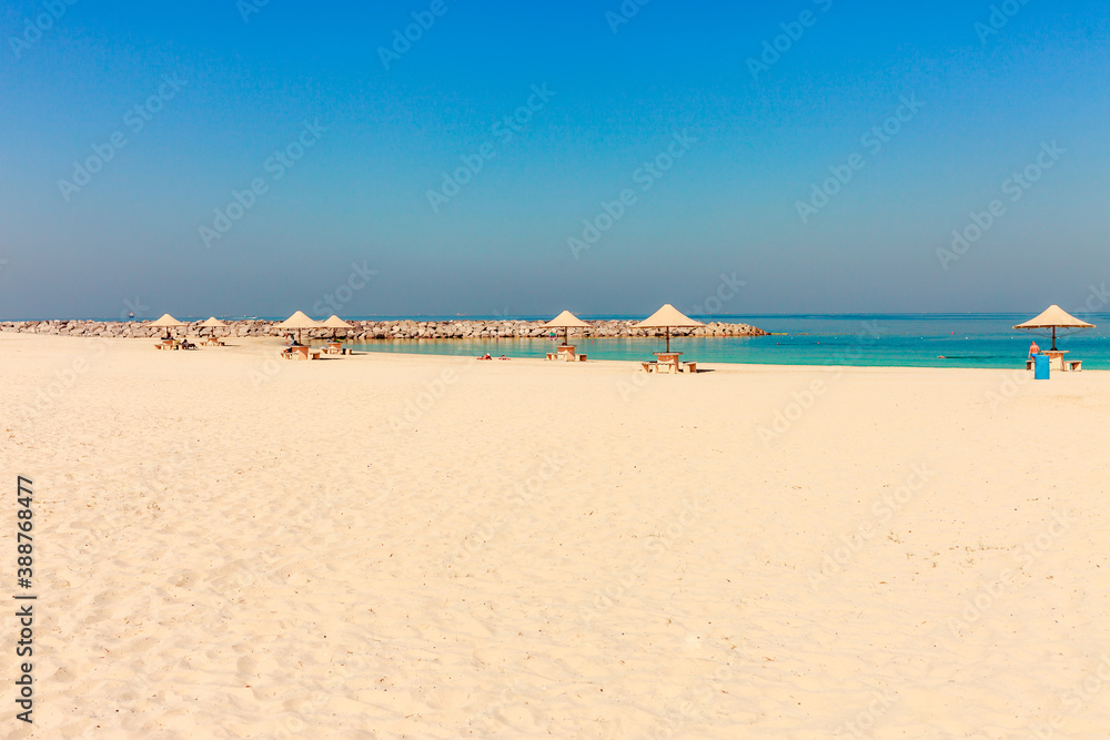 Panoramic view on nice Al Mamzar beach in Dubai, UAE. United Arab Emirates famous tourist destination. Clear blue water Persian gulf, Indian Ocean
