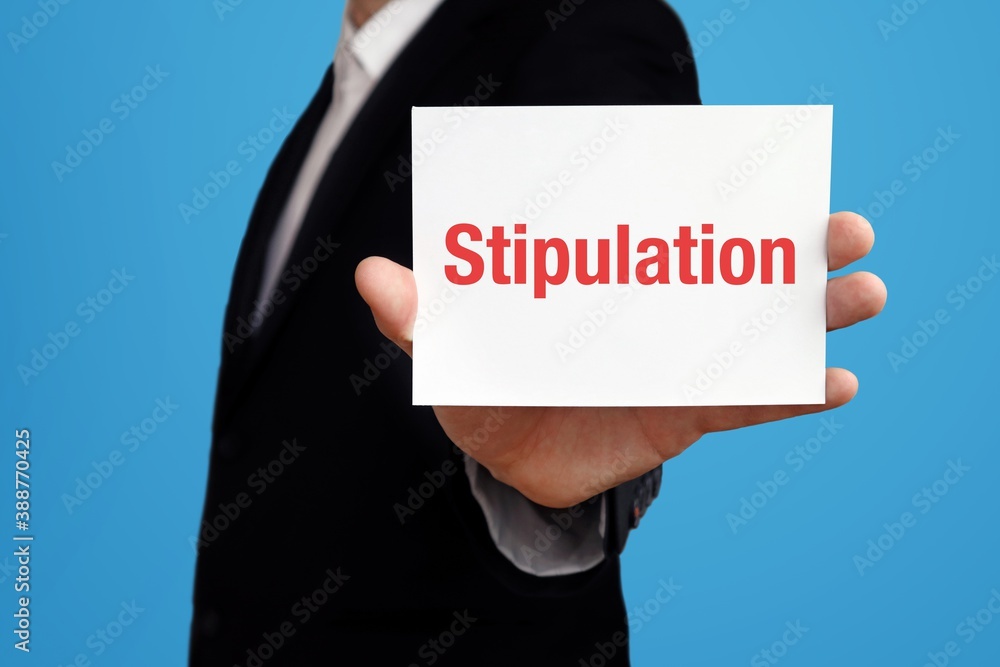 Stipulation. Businessman in suit showing business card with text. Man isolated on blue background Stipulation. Businessman in suit showing business card with text. Man isolated on blue background