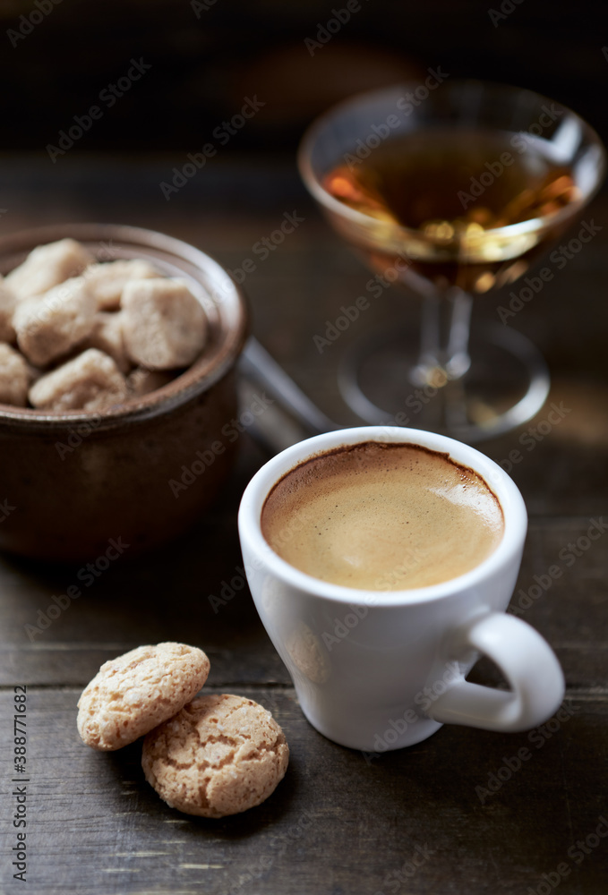 Cup of coffee with amaretti (Italian biscuits) on rustic wooden background. Close up. Cup of coffee with amaretti (Italian biscuits) on rustic wooden background. Close up.