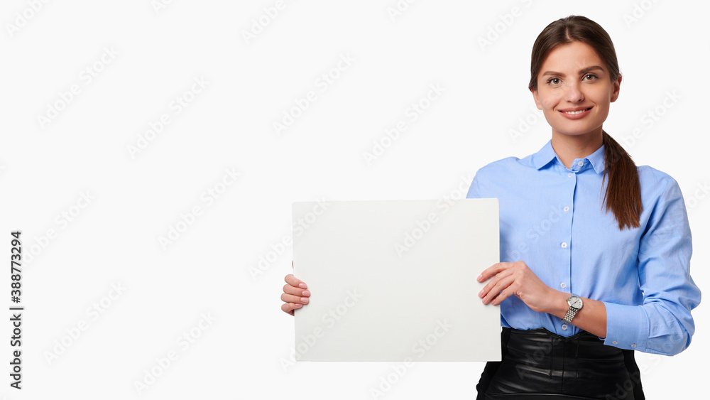 Attractive businesswoman in shirt holding white blank billboard and smiling on white isolated background Attractive businesswoman in shirt holding white blank billboard and smiling on white isolated background