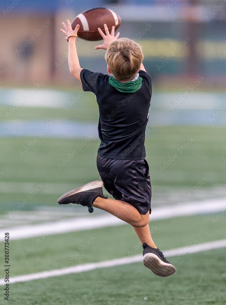 Little boy playing catch and throw with the football
