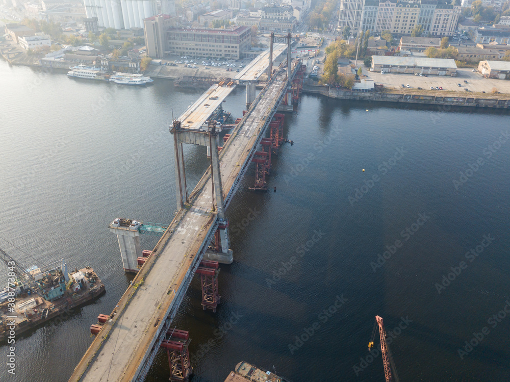 Aerial drone view. Construction of a bridge across the river.
