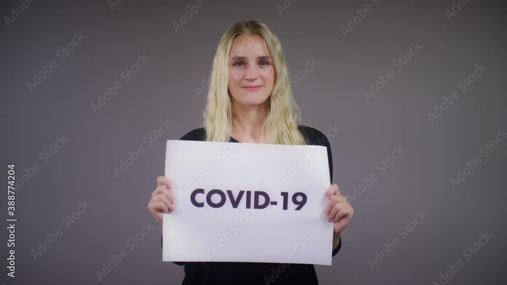 Young Blonde Caucasian Woman Rips Covid 19 Sign Young Blonde Caucasian Woman Rips Covid 19 Sign