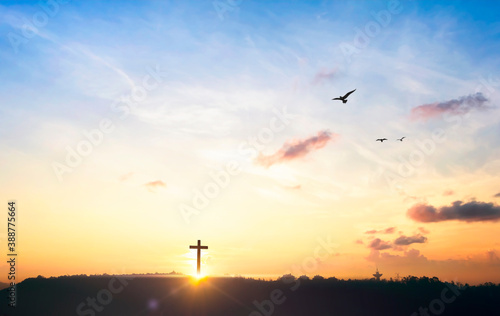 Religious cross concept: Silhouette cross on mountain at sunset background