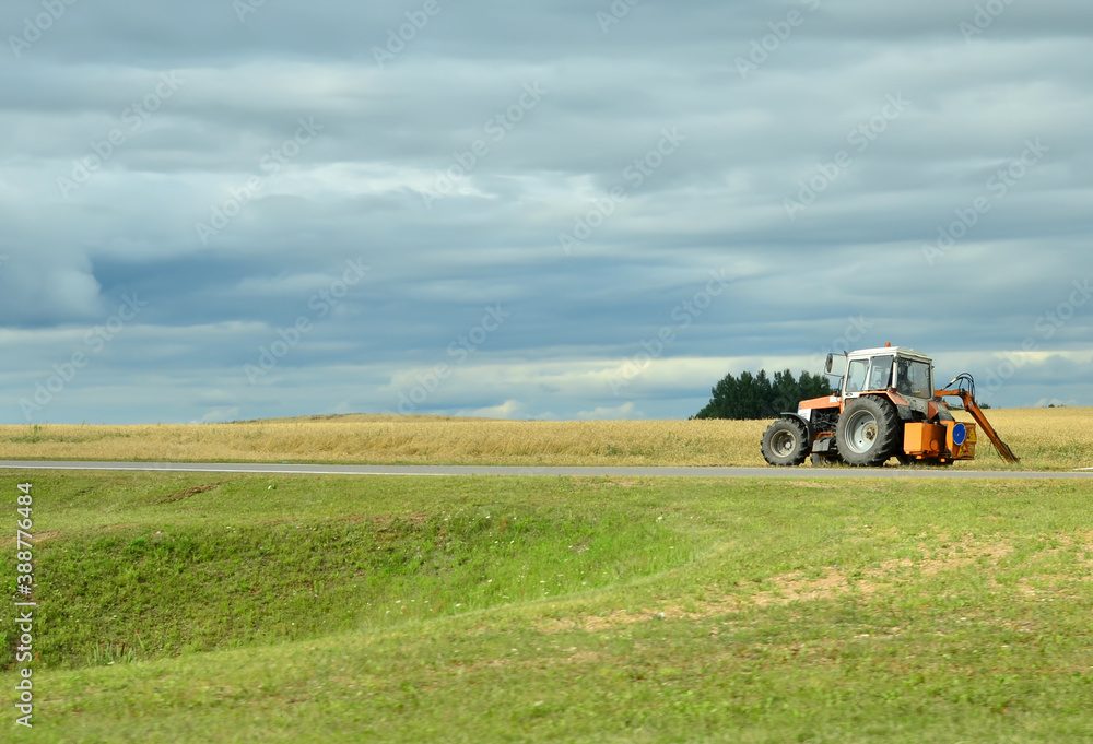 Tractor on the background of an agricultural field Tractor on the background of an agricultural field
