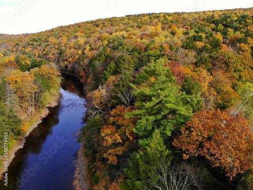 The aerial view of the striking colors of fall foliage by the river near Tunkhannock, Pennsylvania, U.S