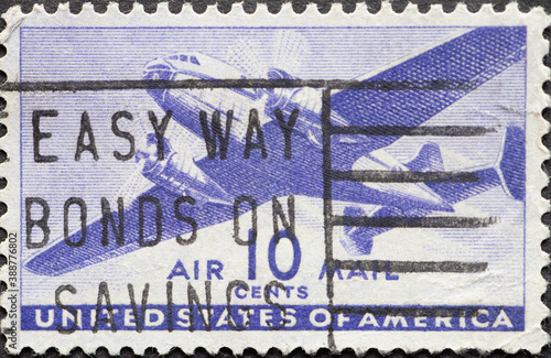 USA - Circa 1941: a postage stamp printed in the US showing a twin-motored transport airplane 10c airmail photo