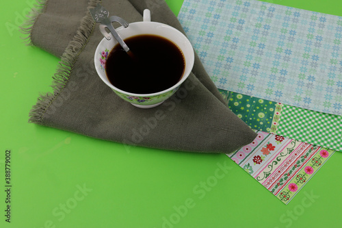 Cup of black coffee with cat spoon, flowers decoration, copy space for your own message photo